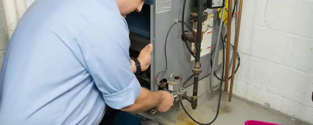 Furnace repair technician inspecting and servicing a home heating system in Cape Coral, FL