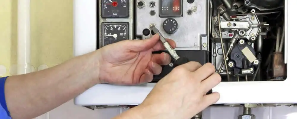 Heating repair technician adjusting boiler controls and components in Cape Coral, FL