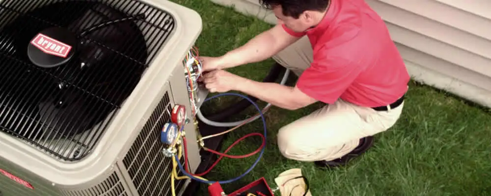 HVAC technician servicing an outdoor air conditioner unit in Cape Coral, FL