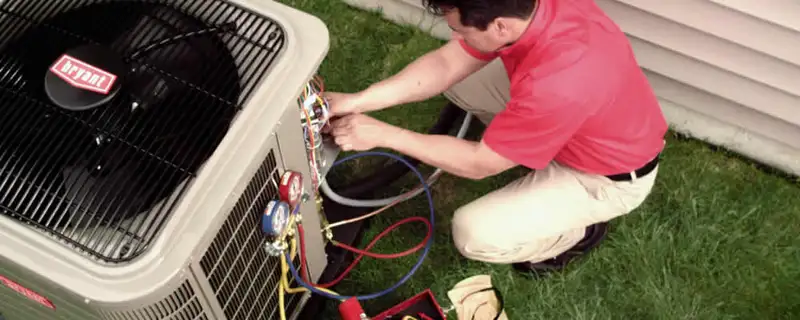 HVAC technician servicing an outdoor air conditioner unit in Cape Coral, FL