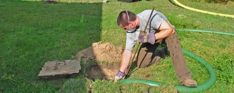 Septic pumping technician servicing a residential septic tank in Cape Coral, FL